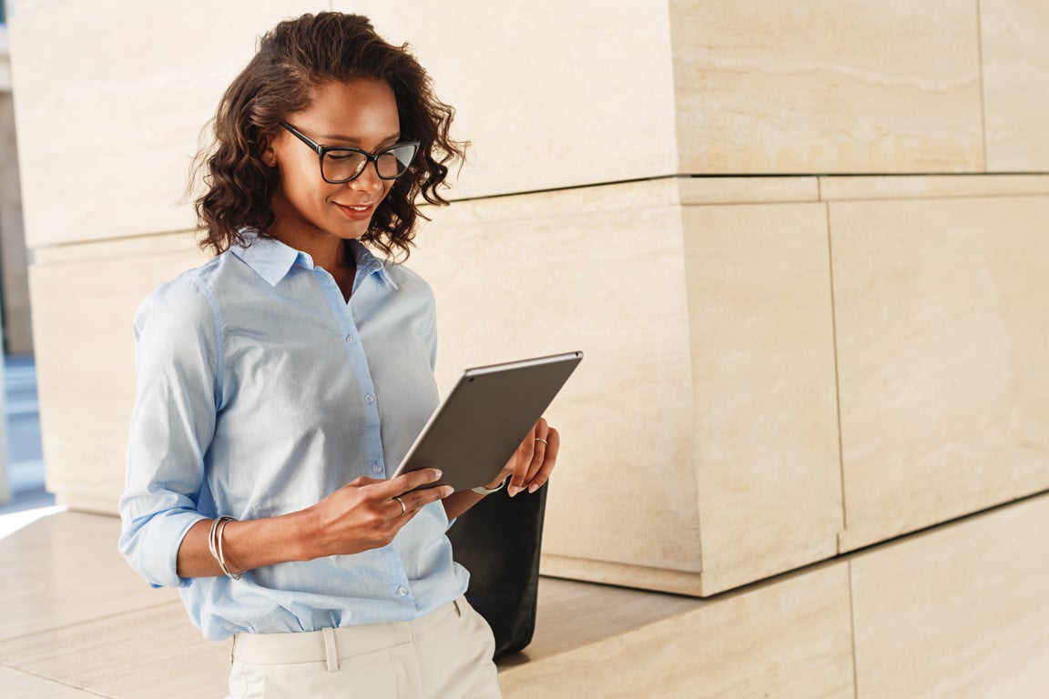 Woman with ipad walking in the office